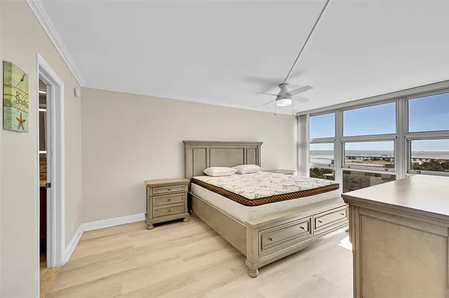 a bedroom with a bed and a large window