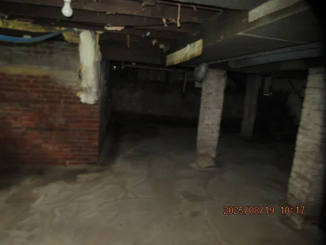 a view of a room with wooden floor and windows