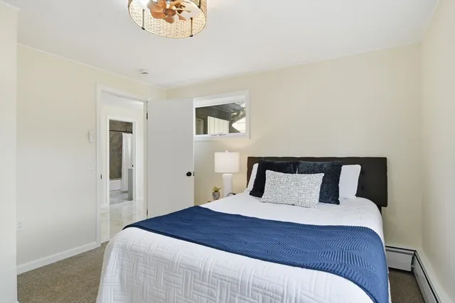 a bedroom with a large bed and a window