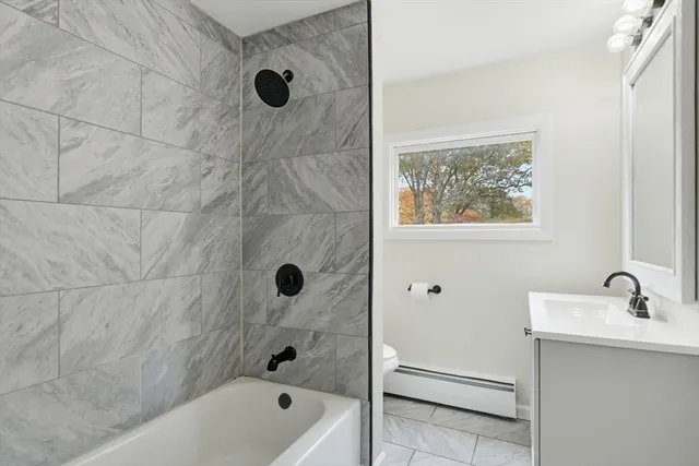 a bathroom with a tub a sink and a shower