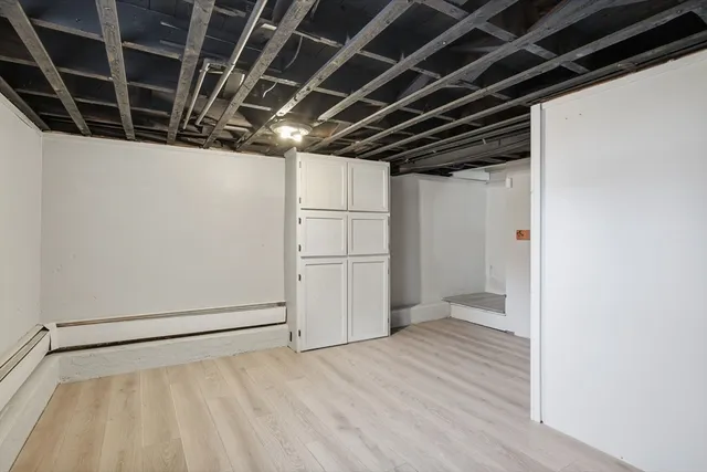 a view of empty room with wooden floor