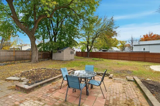 a view of a swimming pool with chair and table