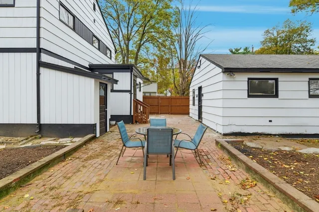 a backyard of a house with yard and outdoor seating