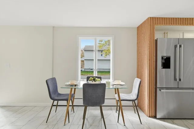 a dining room with furniture and window