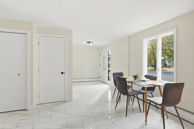 a view of a livingroom with furniture and a window
