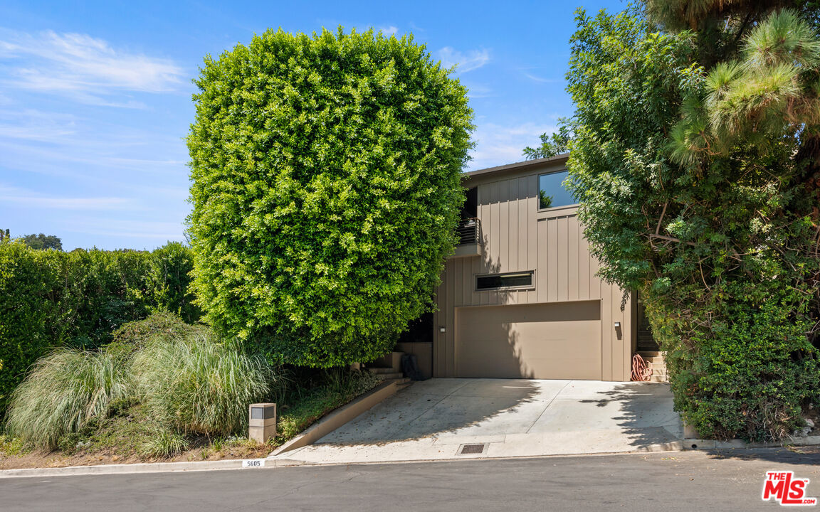 Undisclosed Address Los Angeles, CA 90068 - Photo 2 of 30 a front view of a house with a garden