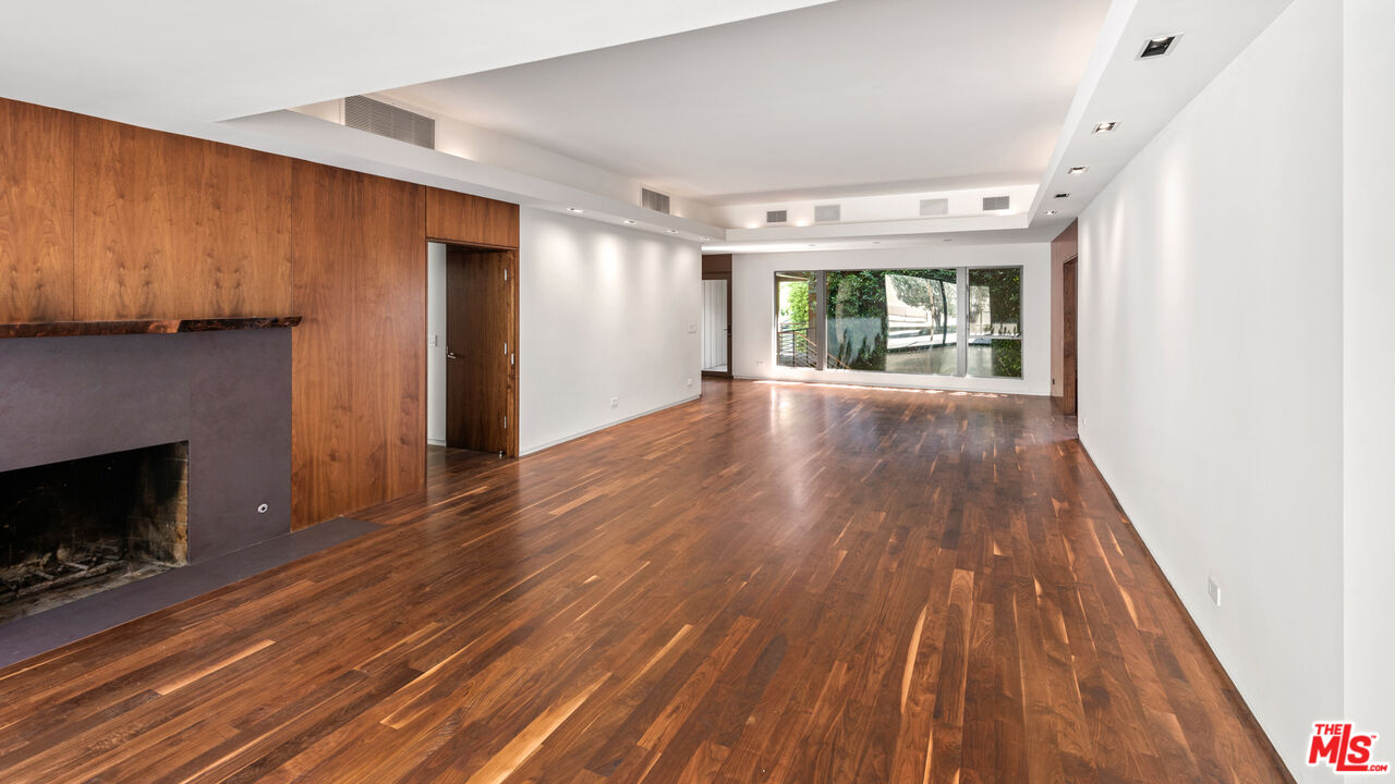 Undisclosed Address Los Angeles, CA 90068 - Photo 7 of 30 a view of empty room with wooden floor and fireplace