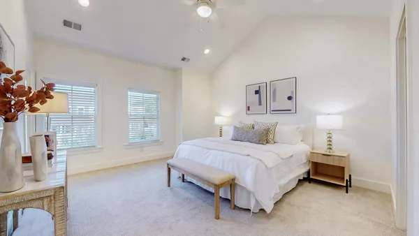 a spacious bedroom with a bed and a couch