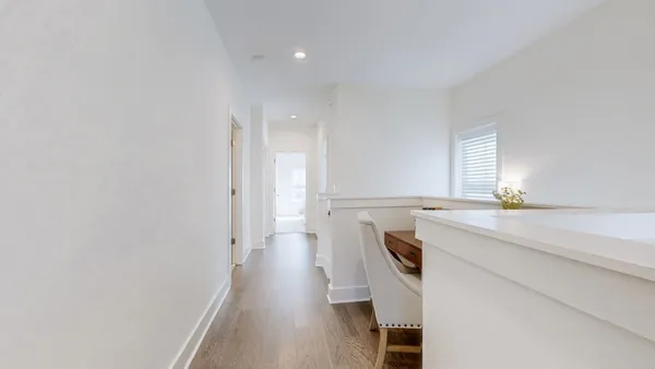 a hallway with a wooden floor and entryway