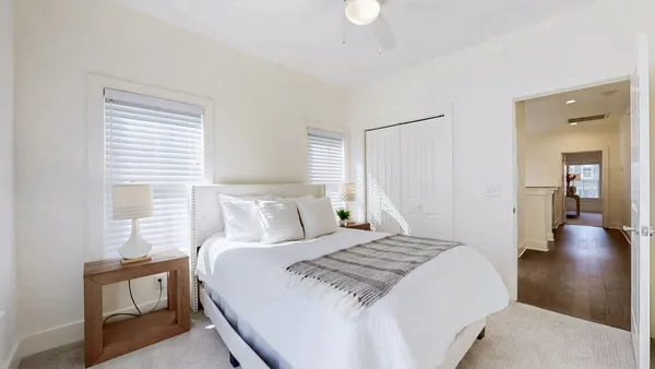 a bedroom with a large bed and a chandelier