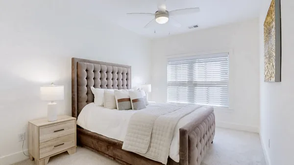 a bedroom with a large bed and a window