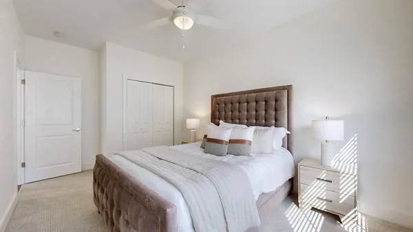 a bedroom with a bed and a lamp