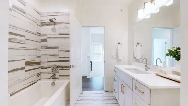 a bathroom with a sink a mirror and a bathtub