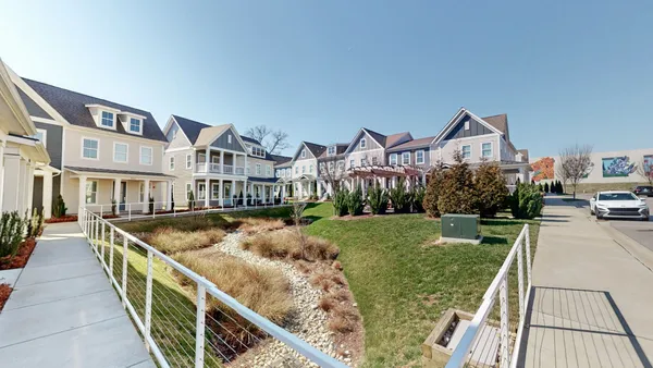 a view of multiple houses with a yard