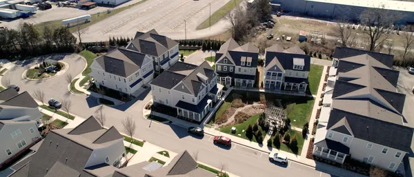 an aerial view of house with yard and mountain view in back