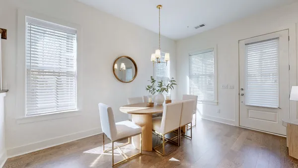 a dining room with furniture a window and wooden floor