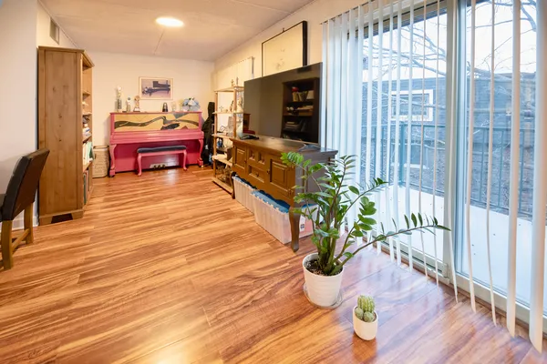 a living room with furniture fireplace and wooden floor