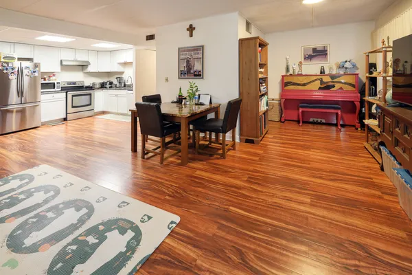 a living room with furniture and a wooden floor