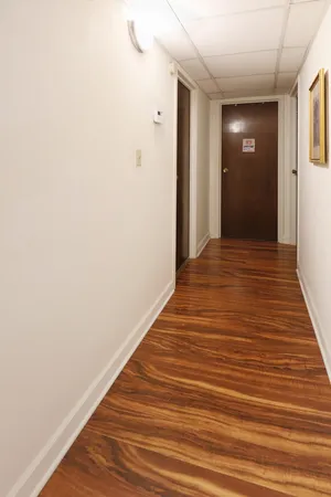 a view of a hallway with wooden floor