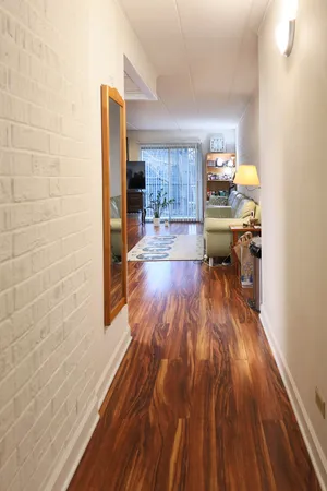 a view of a living room with a wooden floor