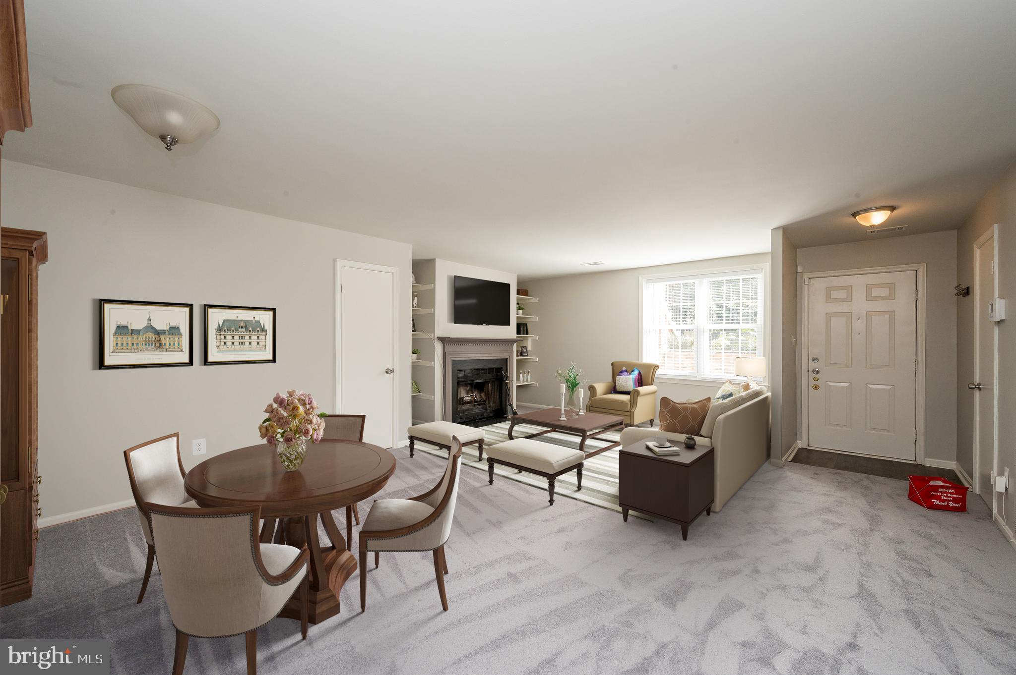 6128 Old Landing Way, Unit 75 Burke, VA 22015 - Photo 11 of 25 a living room with furniture a fireplace and a window