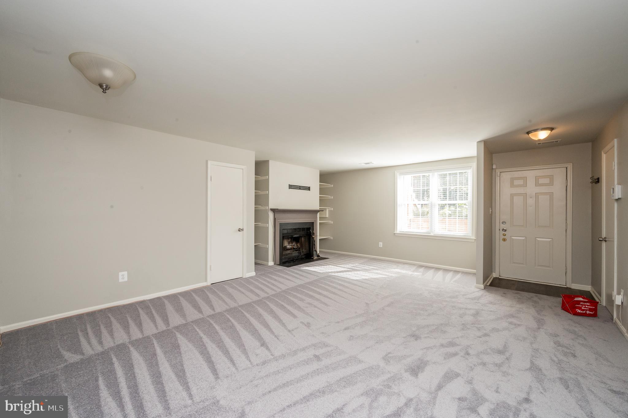 6128 Old Landing Way, Unit 75 Burke, VA 22015 - Photo 12 of 25 an empty room with windows and fireplace