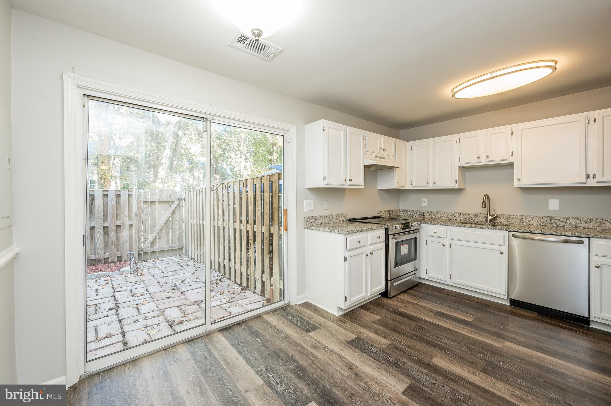 6128 Old Landing Way, Unit 75 Burke, VA 22015 - Photo 15 of 25 a kitchen with granite countertop a stove top oven sink and cabinets