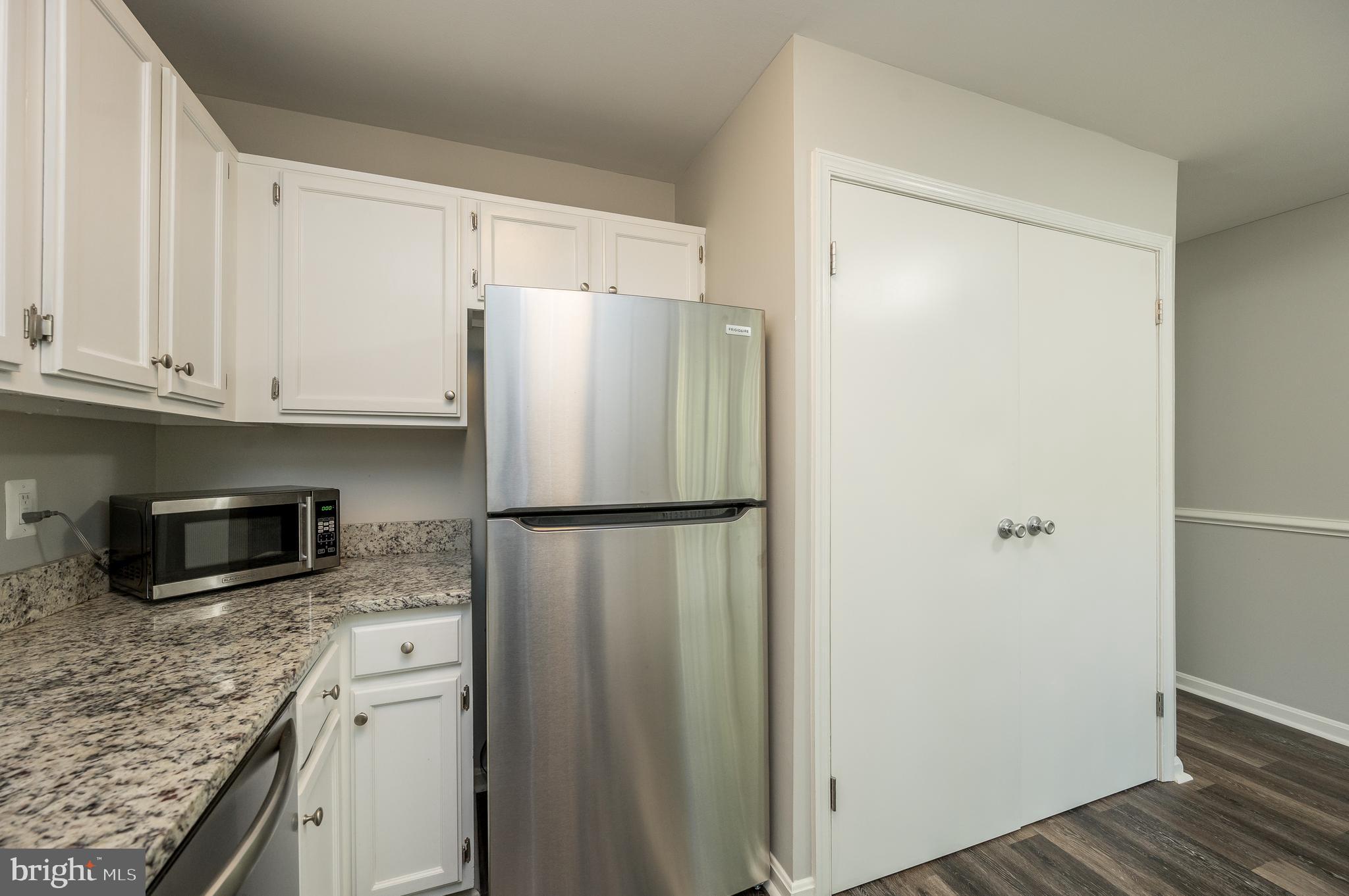 6128 Old Landing Way, Unit 75 Burke, VA 22015 - Photo 18 of 25 a white refrigerator freezer sitting inside of a kitchen