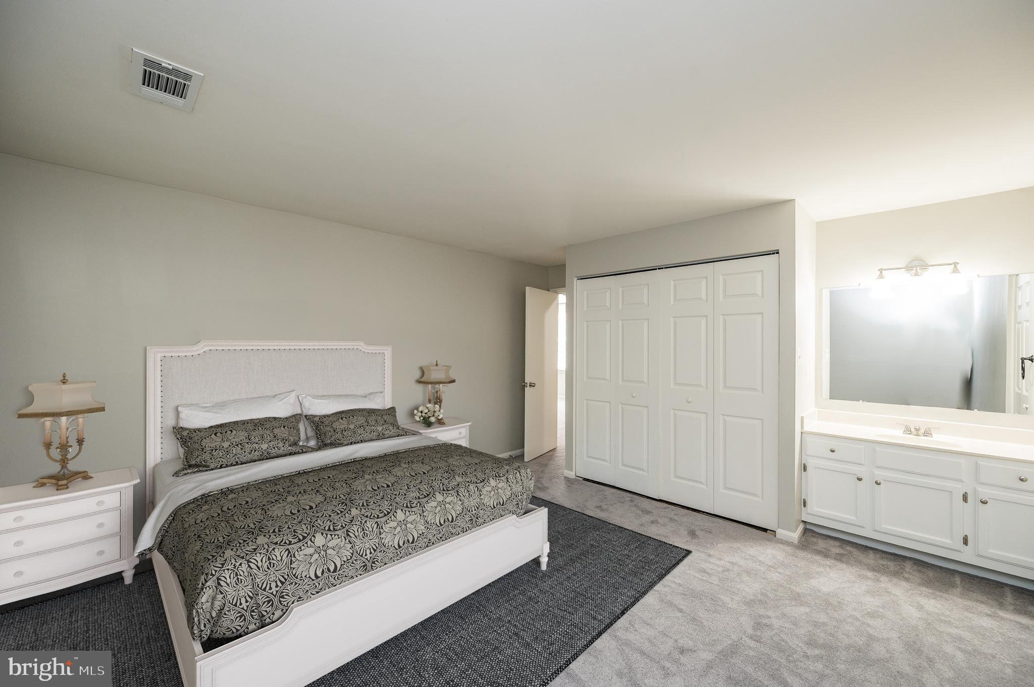 6128 Old Landing Way, Unit 75 Burke, VA 22015 - Photo 19 of 25 a bedroom with a large bed and closet