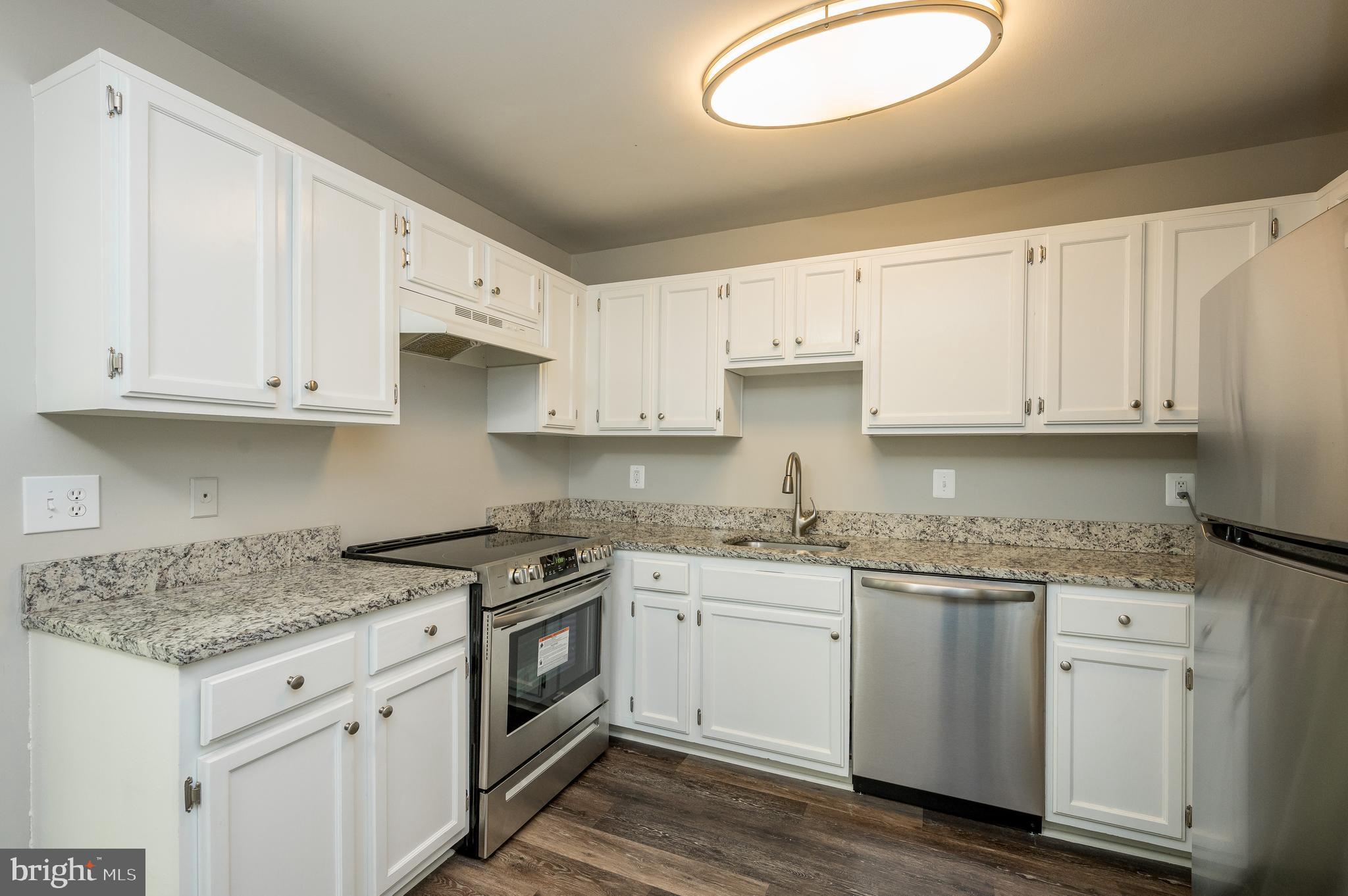 6128 Old Landing Way, Unit 75 Burke, VA 22015 - Photo 3 of 25 a kitchen with stainless steel appliances granite countertop a sink and cabinets