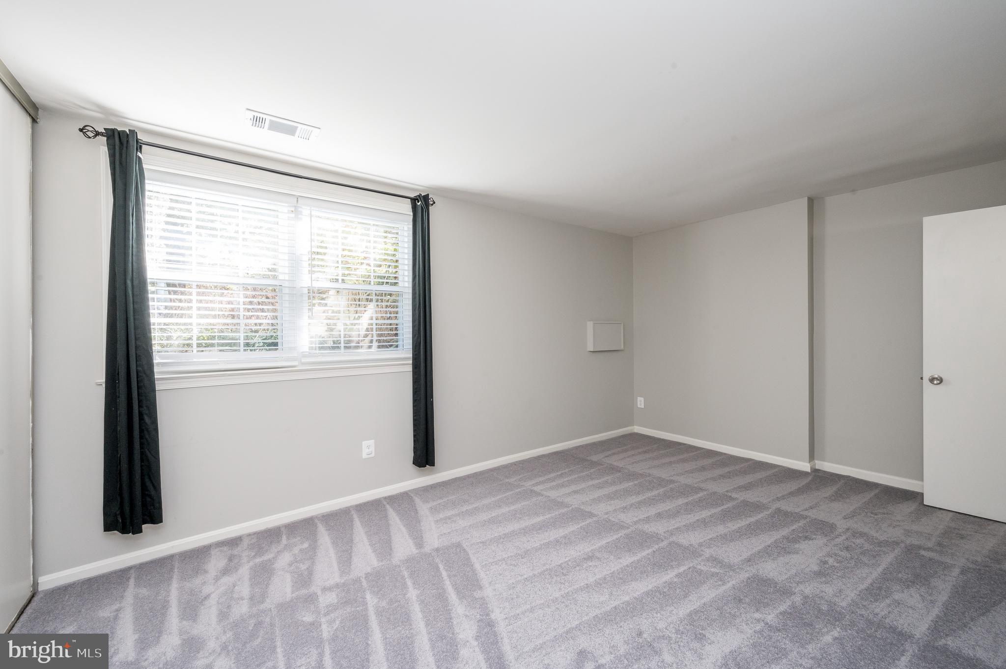 6128 Old Landing Way, Unit 75 Burke, VA 22015 - Photo 22 of 25 a view of an empty room with a window