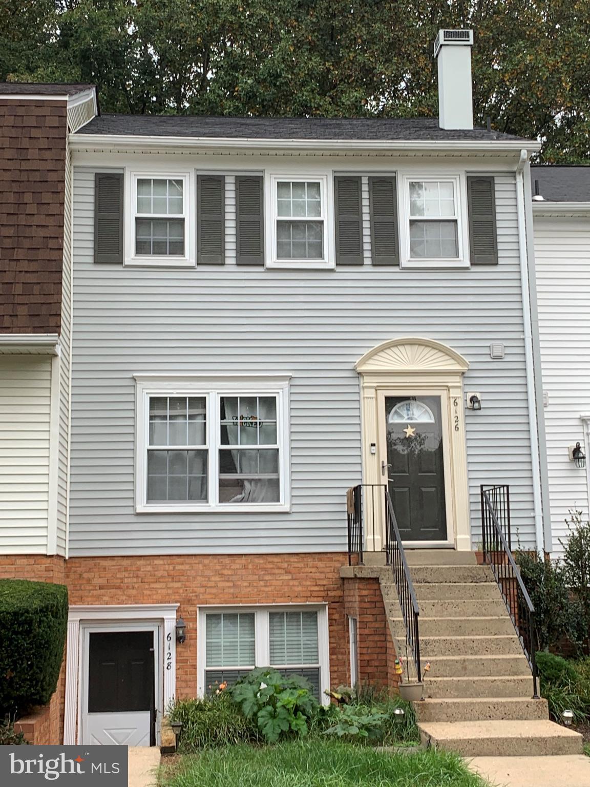 6128 Old Landing Way, Unit 75 Burke, VA 22015 - Photo 7 of 25 a front view of a house with a yard