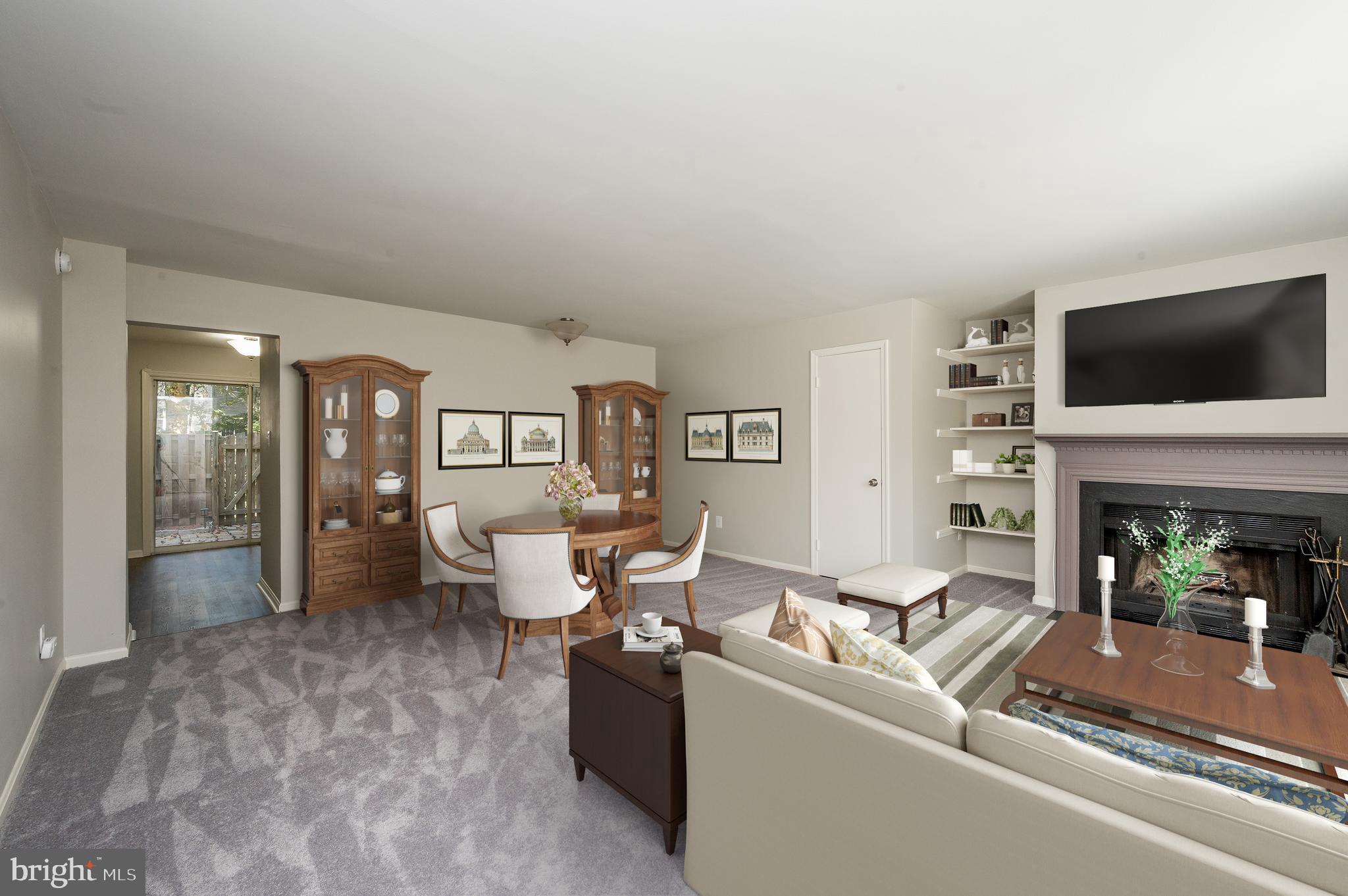 6128 Old Landing Way, Unit 75 Burke, VA 22015 - Photo 9 of 25 a living room with furniture a fireplace and a flat screen tv