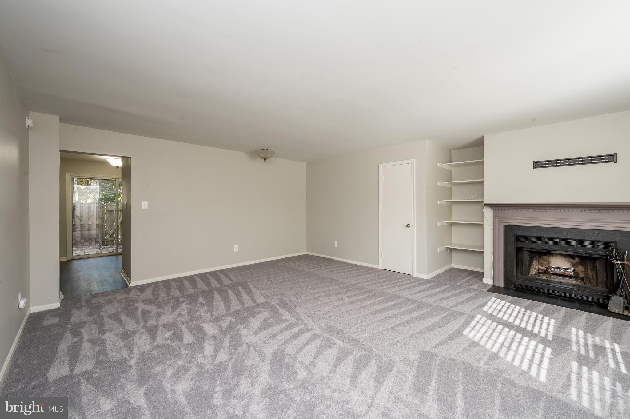 6128 Old Landing Way, Unit 75 Burke, VA 22015 - Photo 10 of 25 a view of empty room with a fireplace