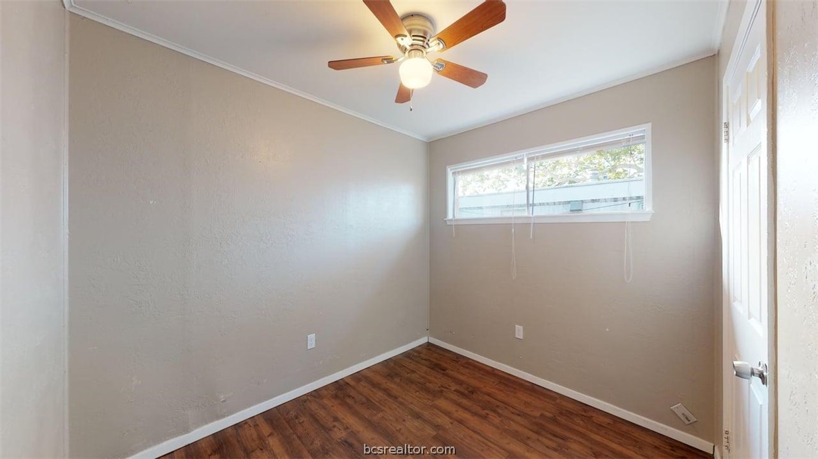 204 Lynn Drive, Unit B Bryan, TX 77801 - Photo 12 of 17 an empty room with windows and fan