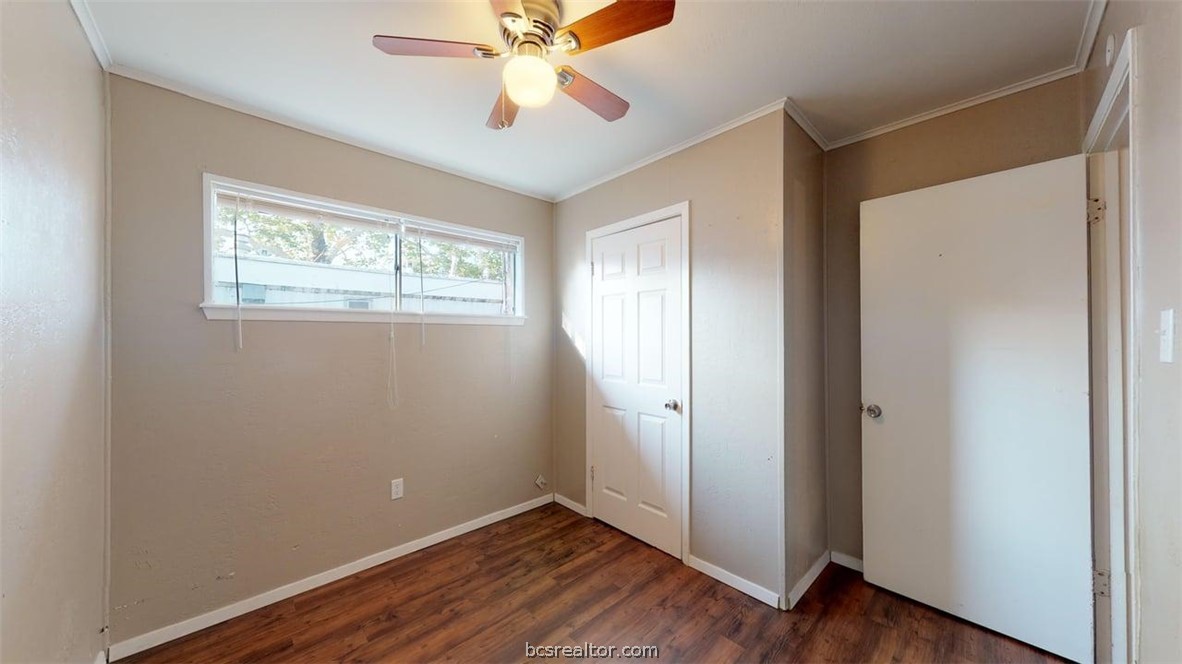 204 Lynn Drive, Unit B Bryan, TX 77801 - Photo 13 of 17 a view of an empty room with wooden floor and a window