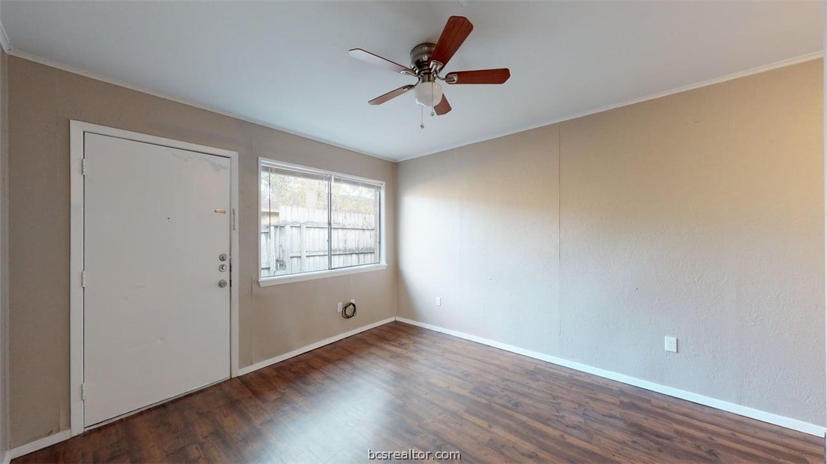 204 Lynn Drive, Unit B Bryan, TX 77801 - Photo 4 of 17 wooden floor in an empty room with a window