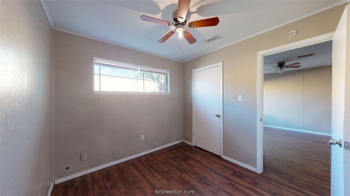 204 Lynn Drive, Unit B Bryan, TX 77801 - Photo 8 of 17 wooden floor in an empty room with a window