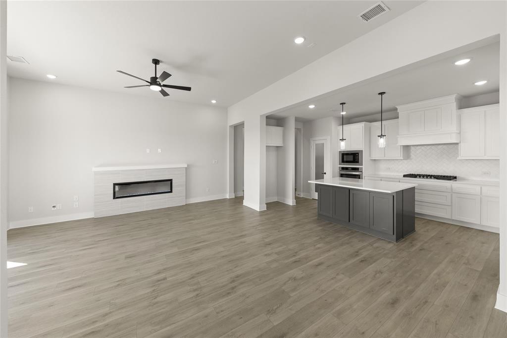 1503 Robinson Road Forney, TX 75126 - Photo 11 of 34 a kitchen with kitchen island a sink stainless steel appliances and cabinets