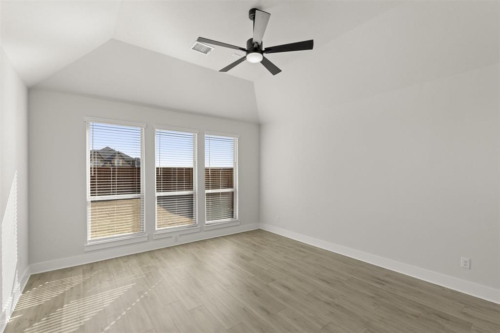 1503 Robinson Road Forney, TX 75126 - Photo 17 of 34 a view of a room with wooden floor and a ceiling fan