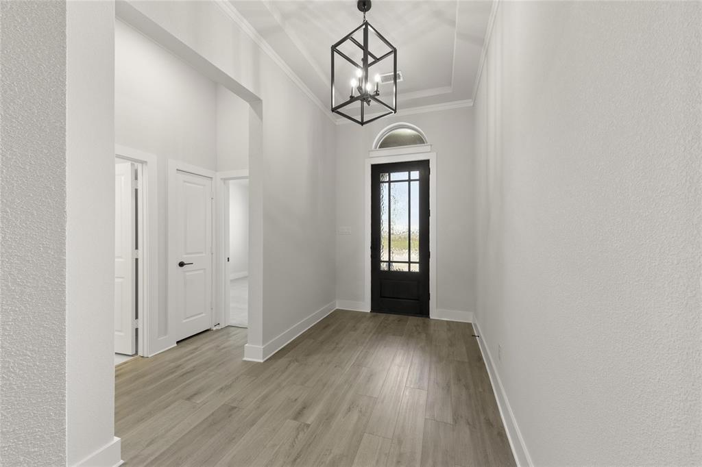 1503 Robinson Road Forney, TX 75126 - Photo 2 of 34 a view of hallway with a mirror and wooden floor