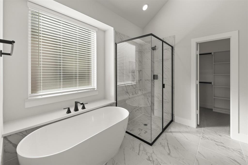 1503 Robinson Road Forney, TX 75126 - Photo 21 of 34 a white bath tub sitting next to a bathroom sink
