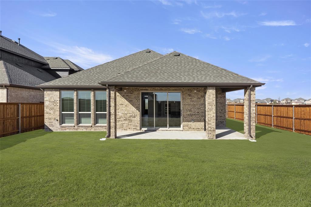 1503 Robinson Road Forney, TX 75126 - Photo 22 of 34 a front view of a house with a garden and yard
