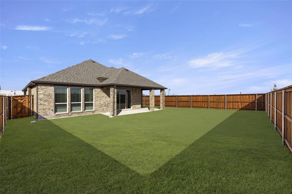 1503 Robinson Road Forney, TX 75126 - Photo 25 of 34 a front view of a house with a garden