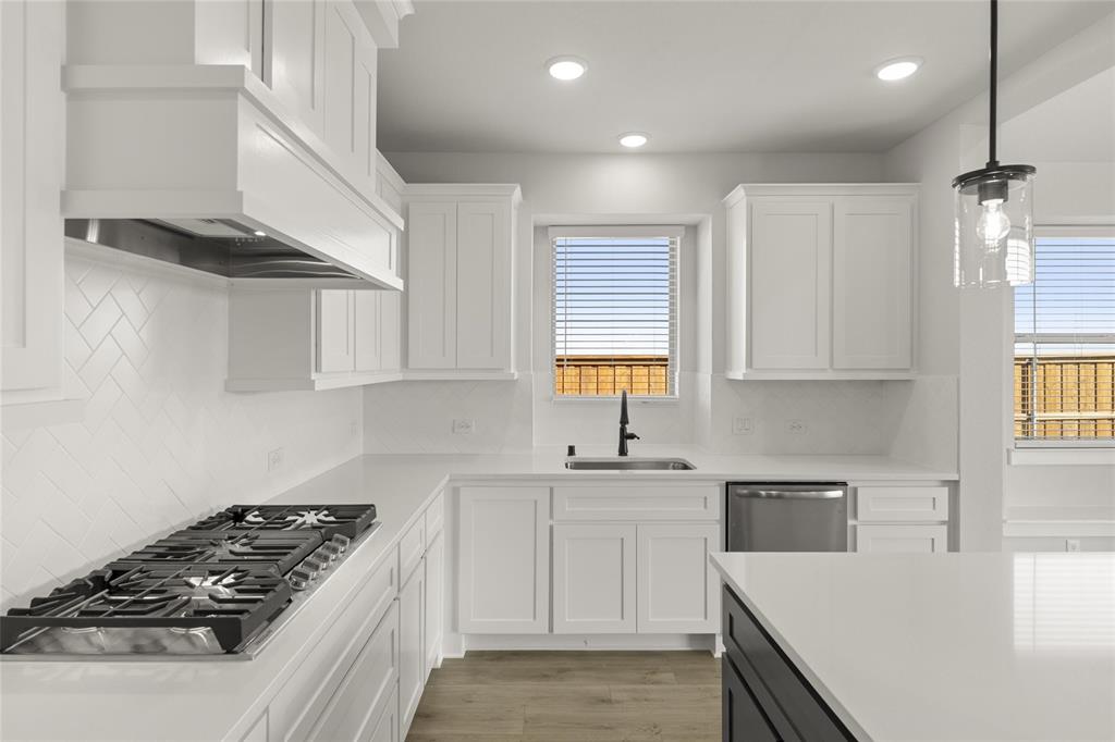 1503 Robinson Road Forney, TX 75126 - Photo 9 of 34 a kitchen with white cabinets and appliances