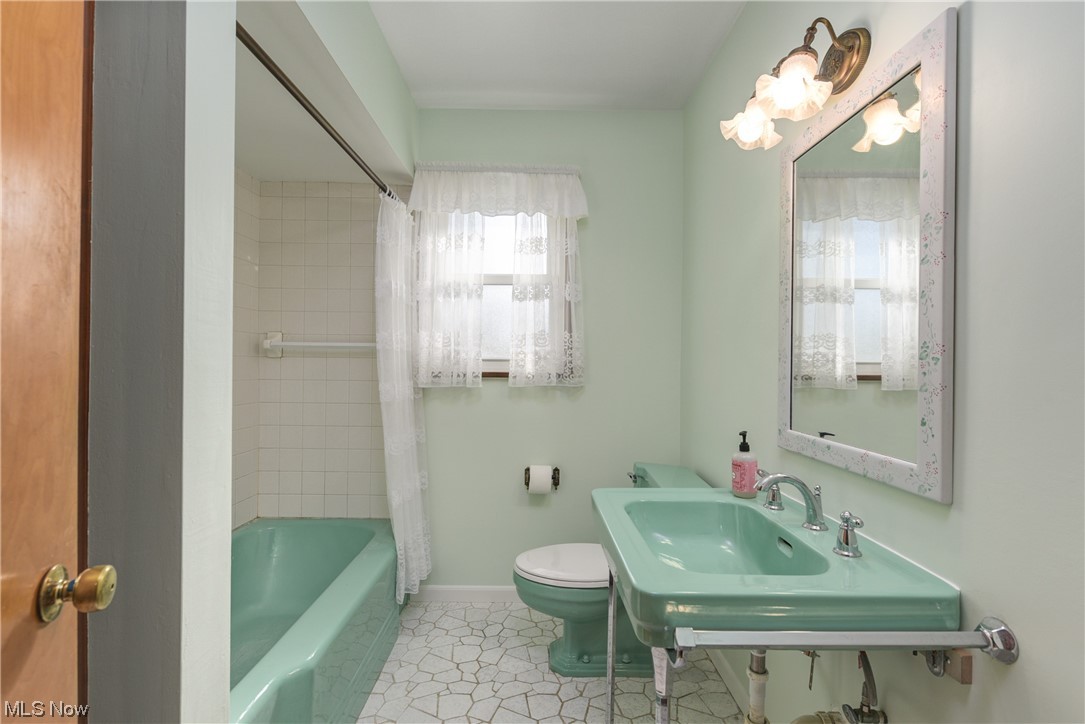 2640 West Sprague Road Cleveland, OH 44134 - Photo 25 of 35 Full bathroom featuring toilet, tile floors, sink, and shower / tub combo with curtain