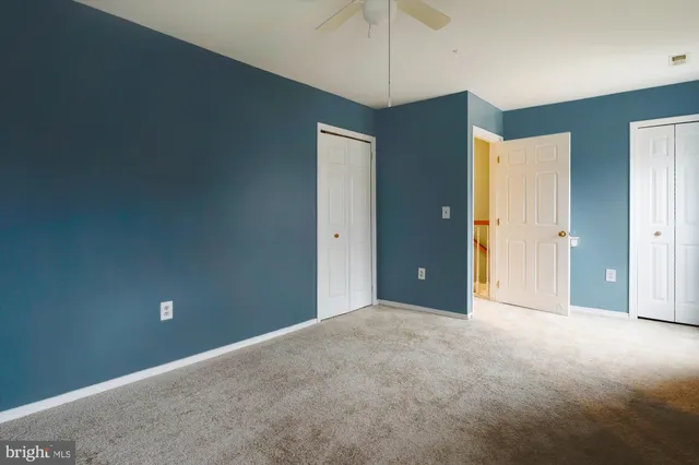a kitchen with kitchen island a refrigerator sink and cabinets