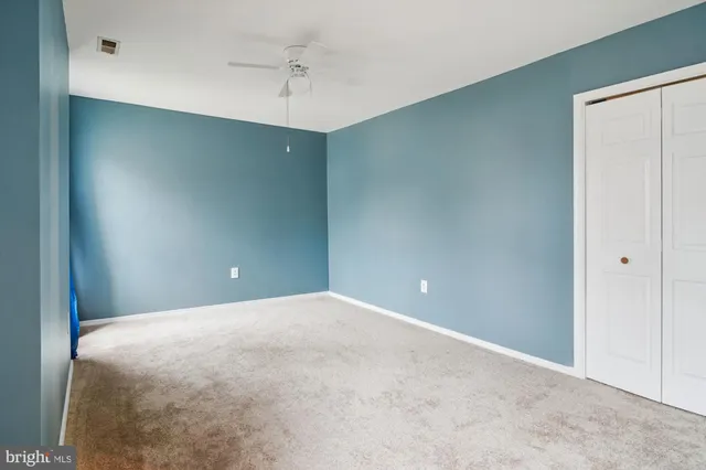 an empty room with windows and closet
