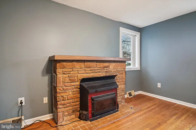 a view of a livingroom with wooden floor and a ceiling fan
