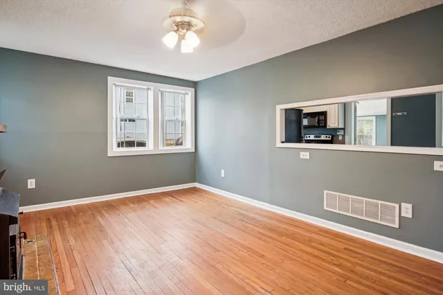 a kitchen with cabinets a sink and white stainless steel appliances
